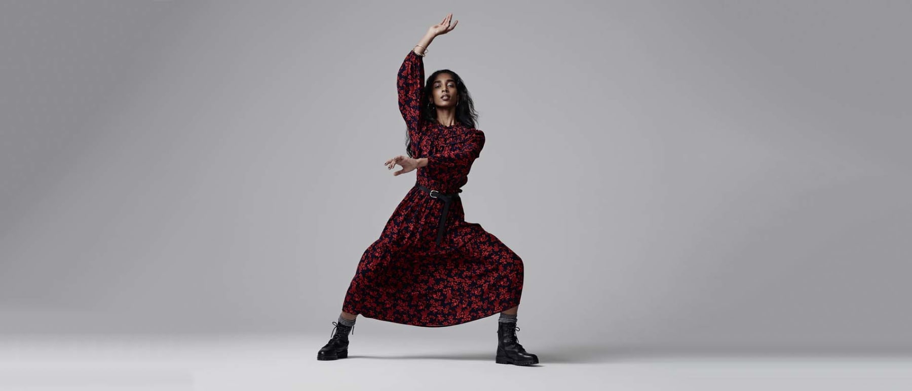 Woman wearing M&S printed midi dress with boots