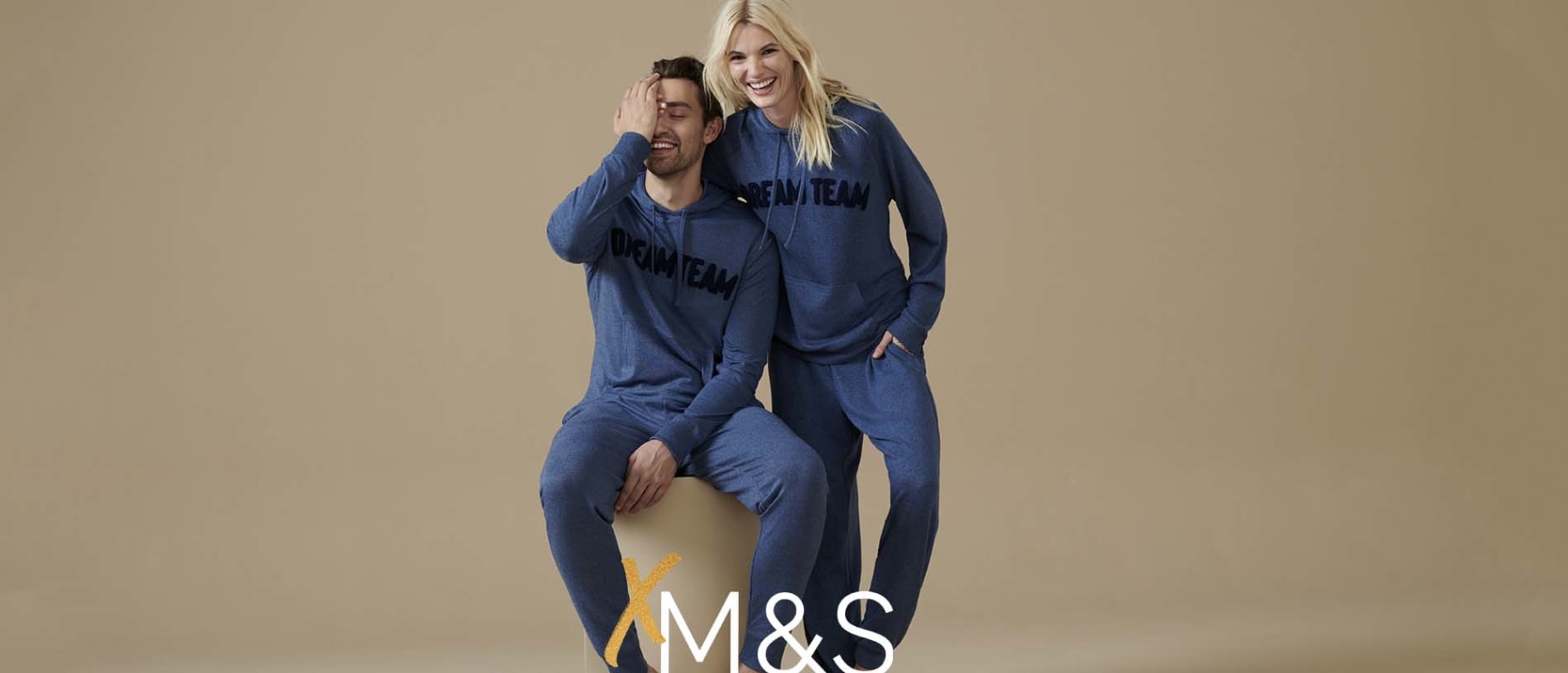 Man and woman wearing M&S christmas pyjamas