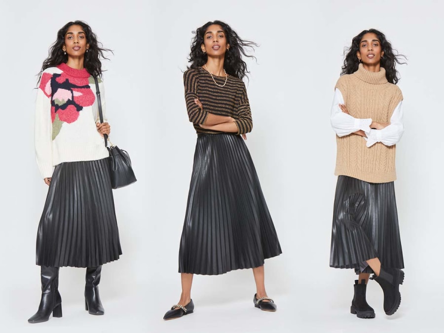 Woman wearing black leather-look pleated midi skirt