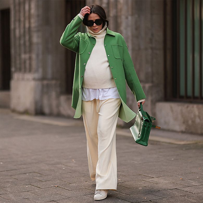 Woman wearing cream loungewear with green coat