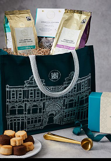Coffee and treats gift bag, including ground coffee and biscuits. Shop now 