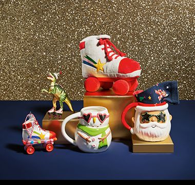 A selection of festive mugs and hanging decorations, and a roller skate pet toy. Shop stocking fillers