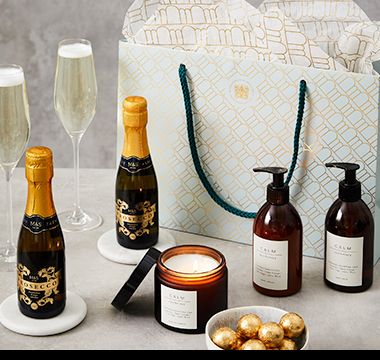 Gift bag containing prosecco, chocolates and Apothecary toiletries.