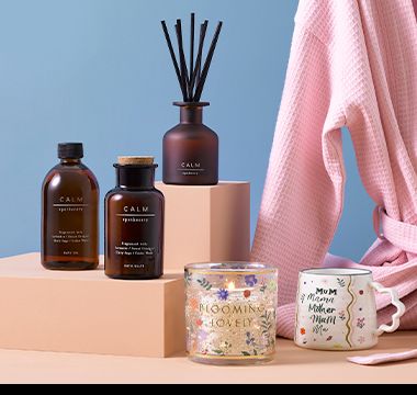 Selection of candles, mug, and dressing gown. Shop all Mother’s Day gifts.
