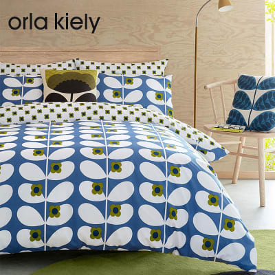 Bed dressed in Orla Kiely blue patterned duvet cover and pillows. Shop Orla Kiely at 127-0Shops