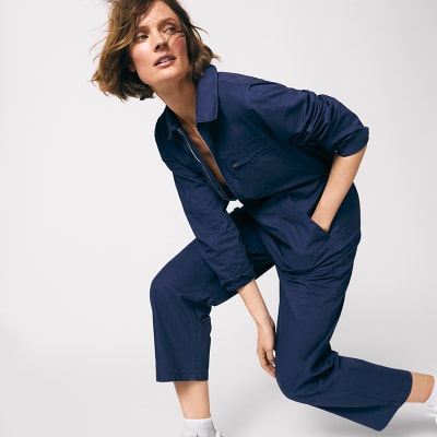 Woman wearing denim jumpsuit. Shop all jumpsuits 