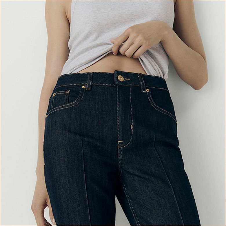 Woman wearing capsule wardrobe staples including cigarette jeans. Shop capsule clothing