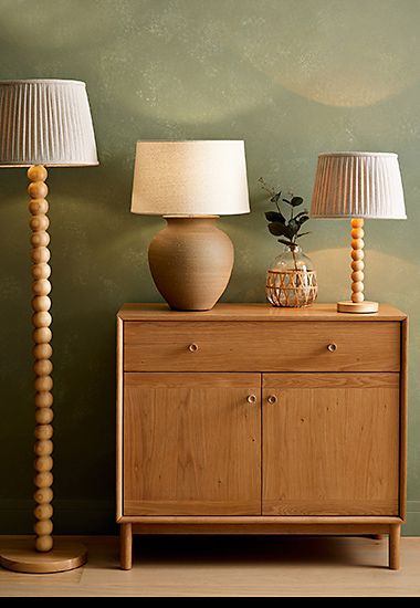 Group of lamps and a wooden sideboard.. Shop lighting