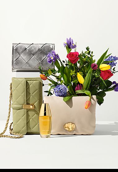A selection of clutch bags with a bunch of flowers. Shop handbags