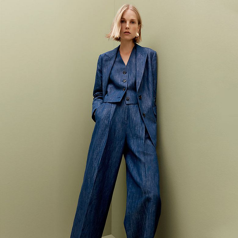 Woman wearing a blue blazer, matching trousers and waistcoat. Shop women’s new in