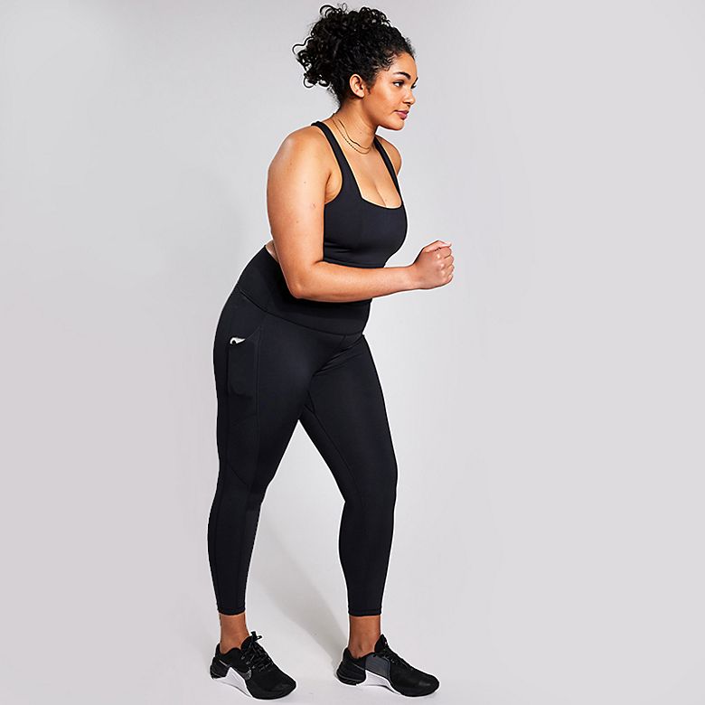 Woman wearing YMO Kickstart black sports leggings and black crop top. Shop sportswear