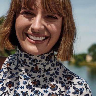 Clemmie Hooper wearing a white and blue floral polo neck