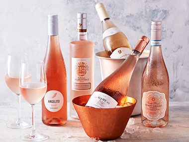 A selection of bottles of rosé wine in an ice bucket