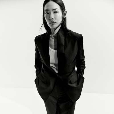 Woman wearing capsule wardrobe staples including a black blazer. Shop capsule clothing. 