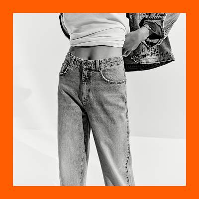 Woman wearing capsule wardrobe staples including wide leg jeans. Shop capsule clothing. 