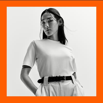 Woman wearing capsule wardrobe staples including a white t-shirt. Shop capsule clothing. 