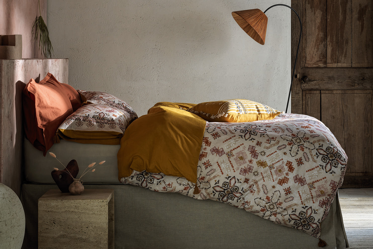 Bed made up with M&S X Fired Earth bedding. Shop the brand