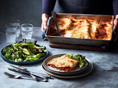 Baked lasagne served with a crisp green salad