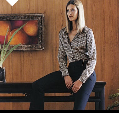 Woman wearing Autograph black trousers, a printed shirt and kitten heels, 2001