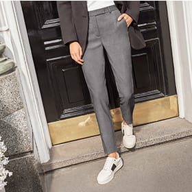 Woman wearing grey tailored trousers