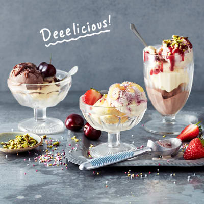 A trio of ice-cream sundaes with fresh fruit, nuts and sauces