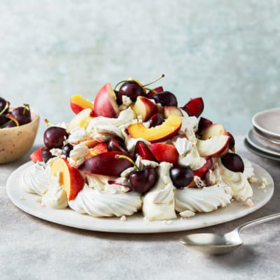 Cheat’s fruity pavlova topped with stone fruits