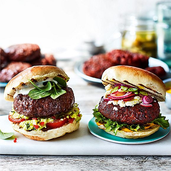 Beef burgers with avocado and tomato on a white slate