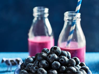 Berry smoothies and a bowl of blueberries