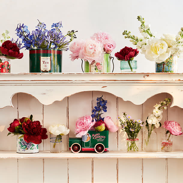 Summer flowers arranged in pots and jars