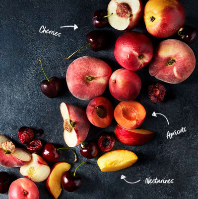 Whole and halved stone fruits including cherries, apricots and nectarines