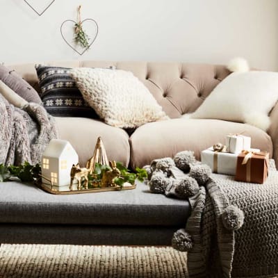 Sofa with cushions and throws in living room