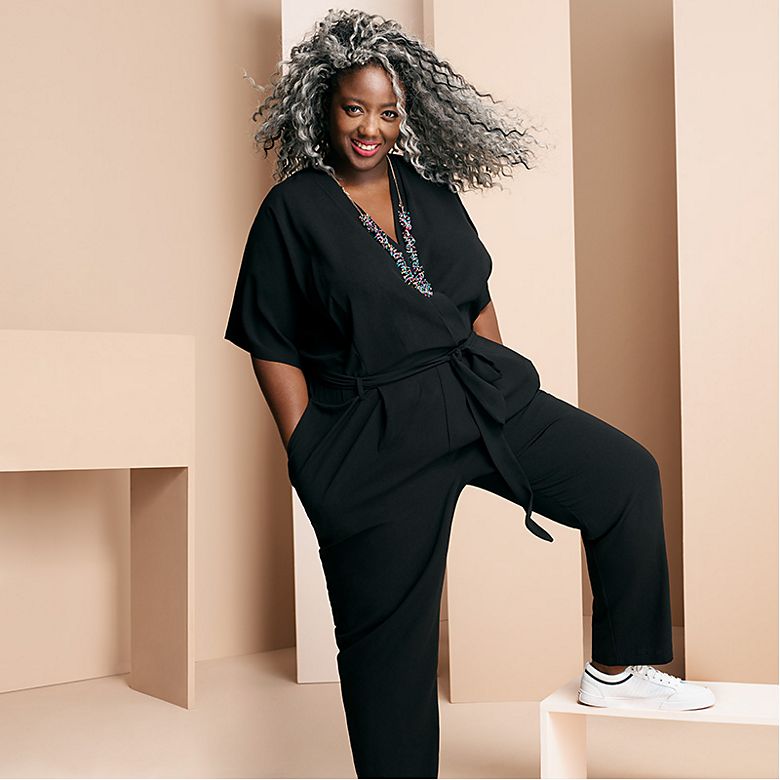 Anne-Marie Imafidon wears black jumpsuit and trainers with statement necklace