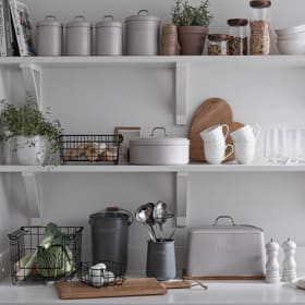 Kitchen utensils and dinnerware on shelves