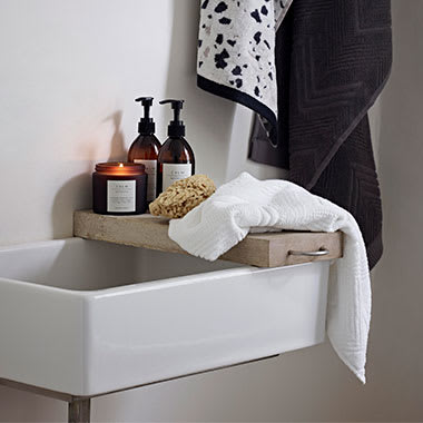 A ceramic sink with M&S towels and toiletries