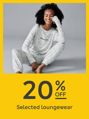 Woman wearing white loungewear jumper and jogging bottoms set