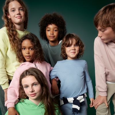 Boys and girls wearing T-shirts and long-sleeved tops. Shop 3 for 2 kidswear