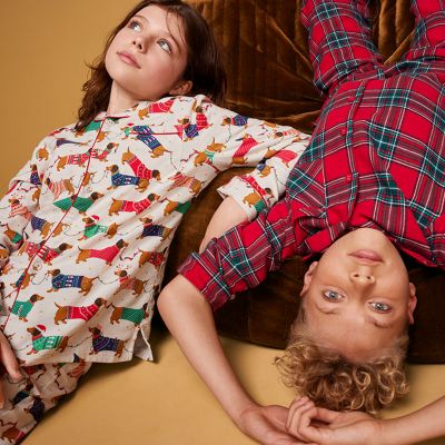 Kids wearing Christmas pyjamas. Shop kids’ nightwear