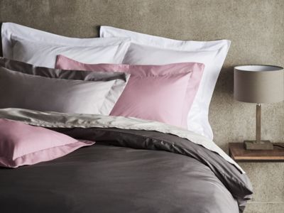 Grey, pink and white Egyptian cotton bed linen on bed
