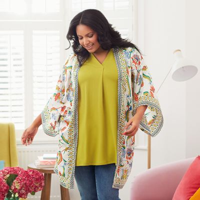 Model wearing a floral kimono, yellow top and blue jeans from the Curve collection