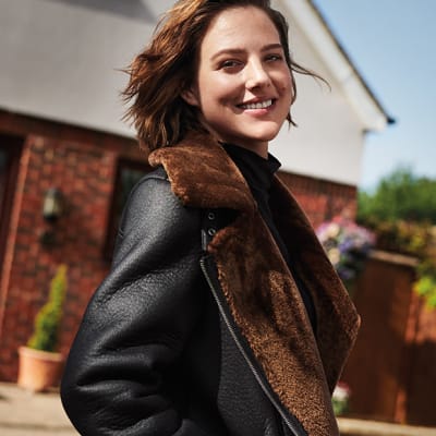 Eliza Cummings wearing a black and brown aviator jacket