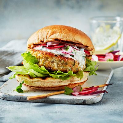 Spicy masala fish burger in a lightly toasted bun with radishes, lettuce and raita 