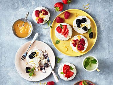 A colourful arrangement of berry-topped pavlovas