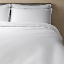 White luxury bedding with pom-pom edging