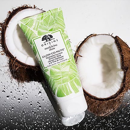 Open coconut and a tube of Origins' Glow-Co-Nuts Hydrating Coconut Moisture Mask