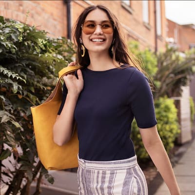 Woman wearing navy regular T-shirt with striped trousers