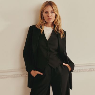 Sienna Miller wearing black suit. Shop Autumn by M&S